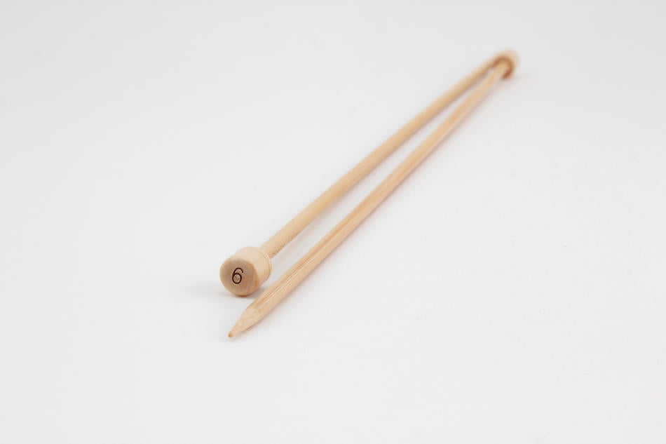 A pair of 12" Bamboo Single-Point Knitting Needles by Accessories Unlimited, one of which has the number 6 printed on the knob at the end. They are placed diagonally on a plain white background.