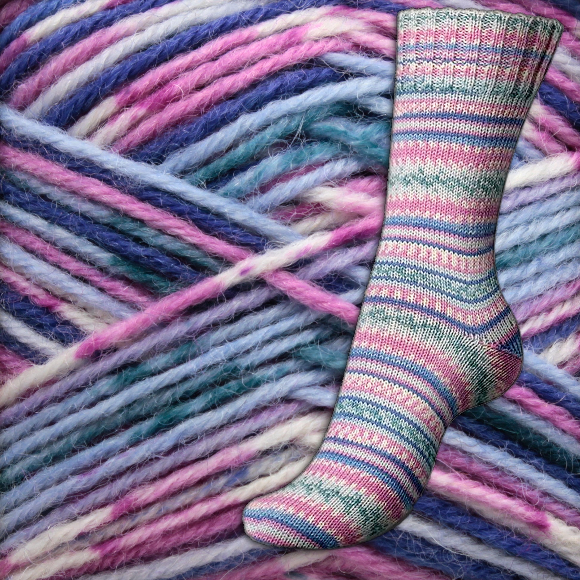 A multicolored knitted sock, crafted from Regia 4-ply Design Line by Arne & Carlos self-pattern sock yarn, is displayed against a backdrop of large skeins in shades of purple, blue, and pink. The sock features a striped pattern that echoes these vibrant colors. The soft and cozy textures of the fingering weight yarn are beautifully highlighted. This delightful creation comes from the esteemed brand Sirdar - Regia, Schachenmayr & Rowan.