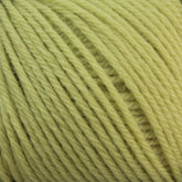 Close-up of a ball of light yellow Baby Blatt by Anny Blatt yarn, showcasing the soft texture and tightly wound strands. The fingering weight fibers from Essentially Felt Studio & Fine Yarn are consistent throughout, with individual fibers slightly visible, giving it a fluffy appearance. Plus, it’s machine washable for easy care.