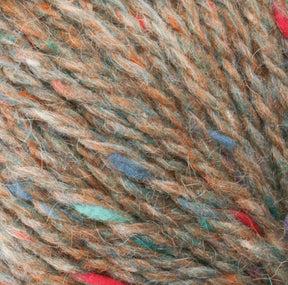 A close-up of Harrisville Designs' Peace Fleece Yarn, showcasing a vibrant mix of brown, orange, blue, green, and red colors. The soft texture of this worsted weight yarn reveals intricately intertwined fibers, forming a speckled pattern throughout.