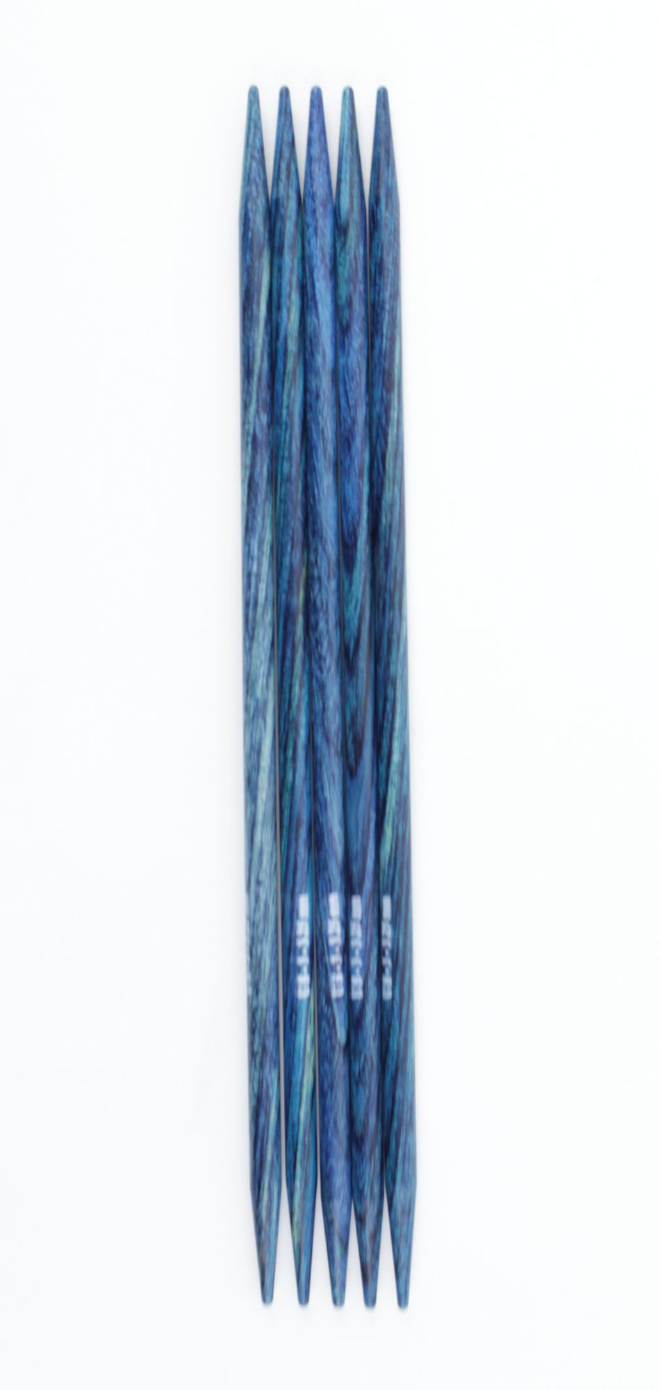 A set of five 5" Dreamz Double Point Knitting Needles by Knitter's Pride from Accessories Unlimited, elegantly arranged in a row on a white background. The laminated birch needles exhibit a stunning variegated blue-green finish and taper to sharp points at both ends.