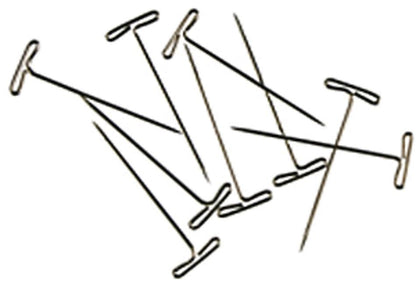 A collection of Accessories Unlimited T-pins lies scattered on a white background. These nickel-plated T-pins feature sharp metal shafts with flat, T-shaped heads, making them ideal for securing fabric or paper in place. They are perfect for tasks like blocking sweaters or pinning notes to a bulletin board.