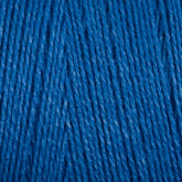 A close-up view of Maurice Brassard's 8/2 Tencel Yarn on a Mini Cone, neatly arranged in parallel strands. The texture appears soft and slightly fuzzy, highlighting the individual threads and their twisted formation. Perfect for weaving projects, the rich blue color is vibrant and consistent throughout the image.