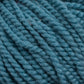 Close-up image of several strands of thick, teal blue Norumbega yarn by Caledonian Dye Works tightly coiled together, showing the texture and fibers in detail. The 100% U.S. wool Norumbega yarn appears plush and slightly fuzzy, highlighting its softness and warmth.