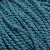 Close-up image of several strands of thick, teal blue Norumbega yarn by Caledonian Dye Works tightly coiled together, showing the texture and fibers in detail. The 100% U.S. wool Norumbega yarn appears plush and slightly fuzzy, highlighting its softness and warmth.