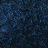 Close-up image of dense, dark blue Victorian Bouclé Mohair Yarn by Caledonian Dye Works. The curls are tightly wound and the texture is thick and lush. The lighting accentuates the rich blue tones and the intricate pattern characteristic of Halcyon's Signature Victorian Collection curls.