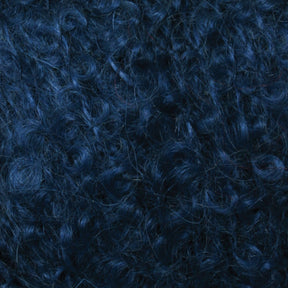 Close-up image of dense, dark blue Victorian Bouclé Mohair Yarn by Caledonian Dye Works. The curls are tightly wound and the texture is thick and lush. The lighting accentuates the rich blue tones and the intricate pattern characteristic of Halcyon's Signature Victorian Collection curls.