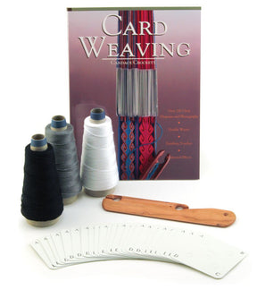 The Halcyon Yarn Deluxe Card Weaving Kit is displayed with a guidebook titled "Card Weaving." The kit includes spools of black, white, and gray pearl cotton thread, a wooden shuttle, and a set of cards labeled with letters.