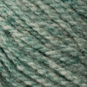 A close-up image of Bartlettyarns' Bartletts Maine Wool - Sport in a stunning teal hue. The sport-weight strands are expertly twisted, highlighting the texture and delicate color variations, with hints of both lighter and darker teal shades. The yarn appears exceptionally soft and ideal for knitting or crocheting projects.