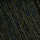 Close-up view of the textured fabric from Harrisville Designs' Harrisville Highland - Cones, featuring dark green and blue threads interwoven together. The material appears thick and somewhat coarse, showcasing individual fibers and a slightly fuzzy surface typical of this product.