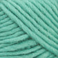 Close-up of a ball of thick, soft teal Lamb's Pride Worsted Yarn by Brown Sheep. The strands are tightly wound, showcasing the texture and slight fuzziness of the yarn. Ideal for Navajo style weaving or felting projects, this yarn adds a touch of elegance to any craft.