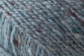 Close-up image of Kingfisher Yarn & Fibre's Jo Sharp Silkroad DK Tweed yarn in blue-green with subtle flecks of darker and lighter hues, highlighting the soft texture and tight twist of the wool, silk, and cashmere fibers.