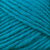 Close-up image of thick, soft Lamb's Pride Bulky Yarn in a vibrant turquoise hue, wound into a skein. The texture of the yarn strands is clearly visible, showcasing the fibers and twists. Perfect for knitters and crocheters, this Brown Sheep yarn promises to add warmth and beauty to Icelandic sweaters or woven blankets.