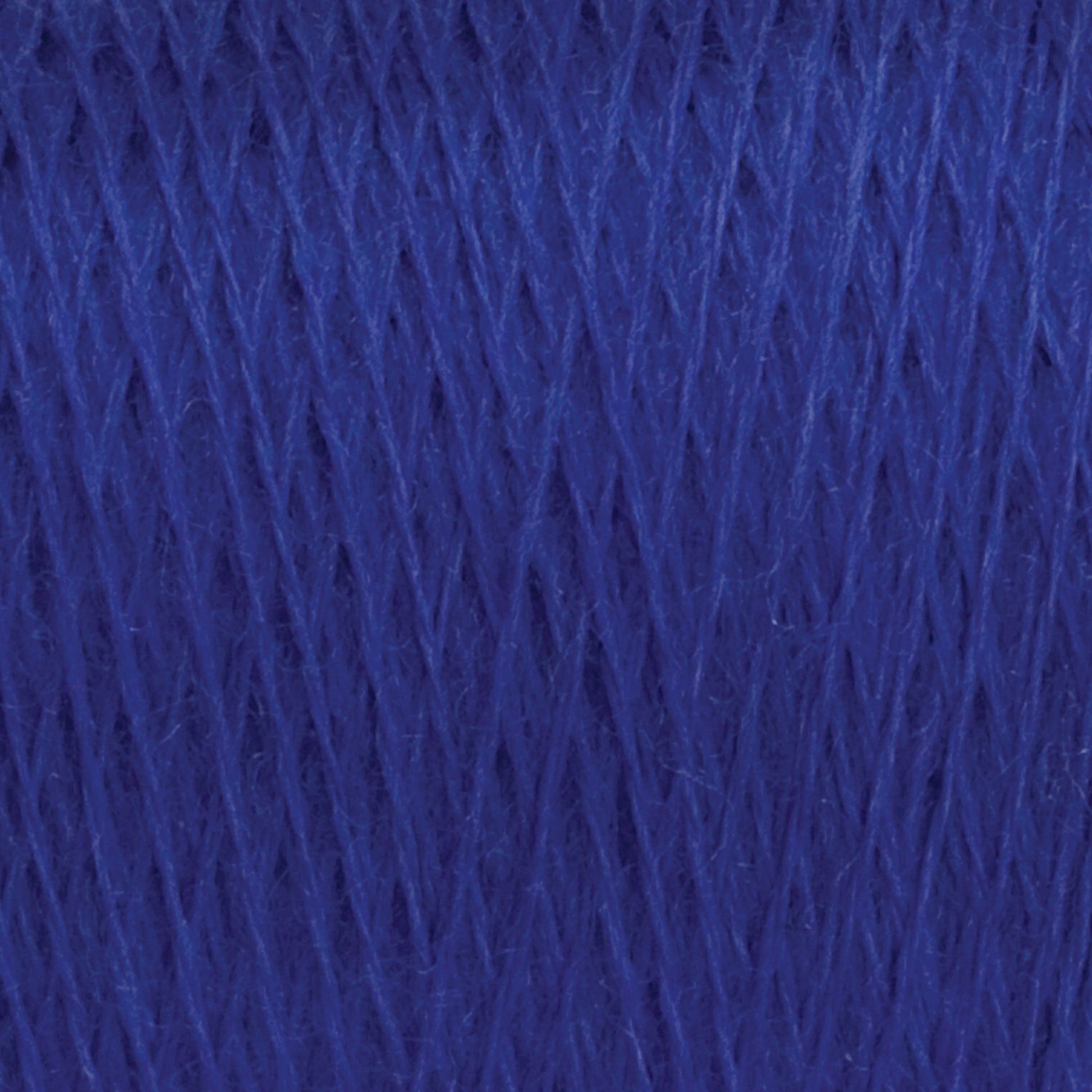 Close-up view of a large cone of JaggerSpun Maine Line 2/20 Yarn by Jagger Brothers, Inc. in blue. The tightly wound strands exhibit a deep, vibrant color with a subtle sheen. The texture of the worsted spun yarns is clearly visible, revealing a soft and slightly fibrous surface.