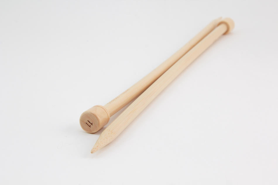 A pair of Bamboo Single-Point Knitting Needles from Accessories Unlimited are laid side by side on a white background. One needle has a pointed end while the other needle has a flat end with the number "14" inscribed on it. These 12" knitting needles are perfect for various projects.