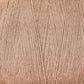 Close-up image of a spool of beige-brown yarn, showing the texture and detail of the fibers. The yarn, Maurice Brassard's 8/2 Cottolin Organic Yarn | Mini-Cone, is tightly wound in an organized manner, highlighting the individual strands and the soft appearance of the material—perfect for crafting elegant tea towels.