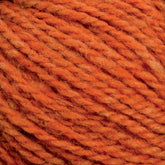 A close-up of orange Harrisville Designs' Harrisville Shetland Yarn - Unwashed Cones strands twisted together, showcasing a blend of lighter and darker orange fibers. The texture appears soft and slightly fuzzy, with visible individual threads contributing to the overall twisted pattern. Ideal for lightweight blankets and Fair Isle knitting designs.