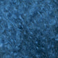 Close-up of a blue, curly, and fuzzy texture, resembling thick wool or fur. The image focuses on intricate curls and fibers, evoking the luxurious feel of Caledonian Dye Works' Victorian Bouclé Mohair Yarn. The uniform shade of blue is enhanced by varied highlights and shadows that bring out the delicate texture.