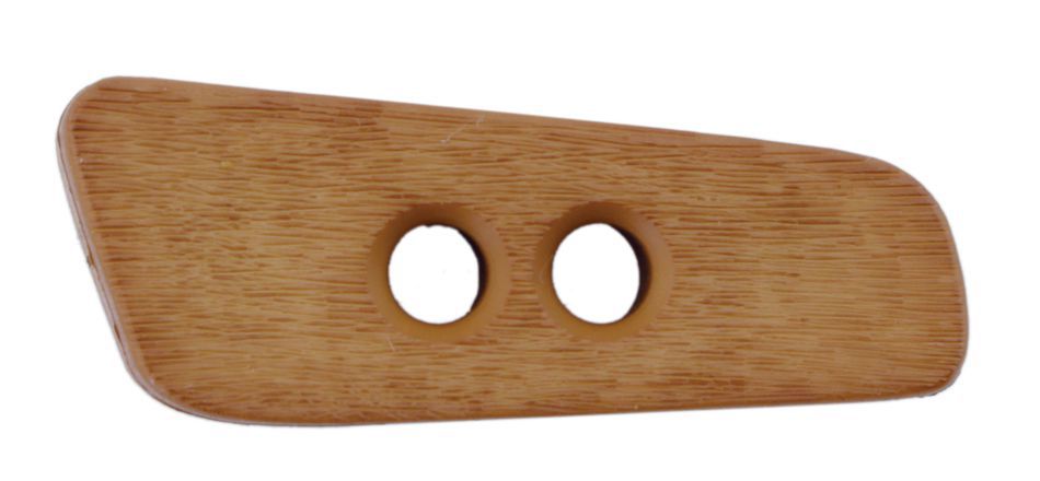 The Faux Wood Button by Dill Buttons of America, Inc. is shown as a light brown, rectangular wooden button with a slightly curved, asymmetrical shape and rounded edges. It features two circular holes in the center for sewing or attachment purposes, adding a touch of authenticity to the faux wood design.