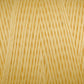 Close-up image of a skein of Maurice Brassard Cotton 8/8 Carpet Warp in a soft, light yellow color, tightly wound into an orderly coil. The yarn fibers are smooth and slightly shiny, with a consistent thickness throughout. This material appears ideal for knitting or crocheting projects.