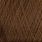 Close-up of dark brown JaggerSpun Maine Line 2/20 Yarn from Jagger Brothers, Inc., showcasing tightly woven fibers that create a textured and intricate pattern. This image emphasizes the natural texture of this medium grade wool, making it ideal for knitting or crocheting projects. The color appears rich and warm, with subtle variations in shade.