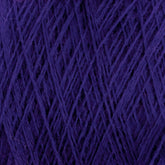 A close-up of JaggerSpun Maine Line 3/8 Yarn in purple, from Jagger Brothers, Inc., reveals a complex and dense pattern of interwoven threads. The texture is soft and fibrous, indicating a thick and cozy material suitable for knitting or crocheting projects on a large cone.