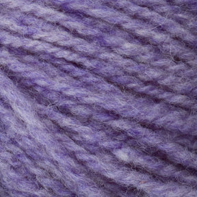 Close-up image of soft, textured Bartletts Maine Wool - Sport in shades of purple and lavender intertwined. The yarn appears fluffy and thick, highlighting its woven and fibrous detail, showcasing the quality craftsmanship of Bartlettyarns.
