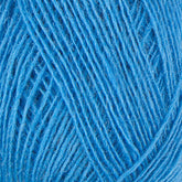 Close-up image of Einband Lopi, a vibrant blue yarn by Berroco, Inc., meticulously wound into a ball to highlight its texture and intricate strands, ideal for lace knitting projects.