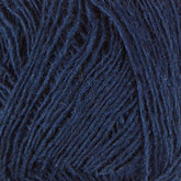 Close-up of strands of dark blue Einband Lopi by Berroco, Inc. The texture appears soft and slightly fuzzy, with the individual fibers visible. The yarn is densely wound together, creating a patterned, intertwined look.