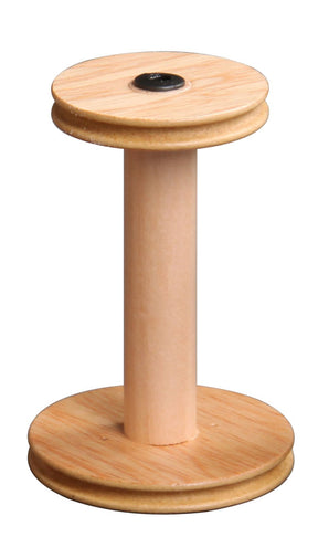 The Ashford Standard Bobbin by Ashford Handicrafts Limited is a vertical wooden spool with two flat, circular ends and a cylindrical rod connecting them. The spool is light brown and empty, with the top end featuring a small black circular mark at its center.