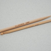 Two Bryson Distributing, Inc. Bamboo Knitting Repair Hooks, perfect for stitch repair and knitting projects, lay side by side on a light gray surface. One hook is labeled "CLOVER 4.5 mm" and the other "CLOVER 3.5 mm." Both bamboo hooks have smooth, polished finishes, making them essential knitting repair tools.

