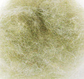 A close-up view of a tangled mass of Harrisville Dyed & Carded Wool Fiber from Harrisville Designs. The fibers are intertwined loosely, creating a soft, fuzzy appearance with a mix of pale, heathered colors.