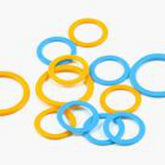 The image showcases a variety of Soft Stitch Ring Markers from Bryson Distributing, Inc., featuring an assortment of blue and yellow rings scattered on a white surface. The markers come in different sizes, with some larger and others smaller, resembling colorful rubber bands in their vibrant hues.