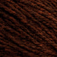 Close-up image of Harrisville Designs' Harrisville Shetland Yarn - Unwashed Cones. The strands are tightly spun together, showcasing a blend of dark and lighter brown fibers reminiscent of classic Fair Isle knitting designs, creating a rich, earthy look. The image highlights the yarn's thickness and fibrous details.