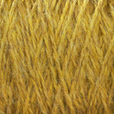 Close-up image of Harrisville Designs' Harrisville Shetland Yarn - Unwashed Cones, showcasing the detailed texture and interwoven fibers in a crisscross pattern. The yarn exhibits a soft, fuzzy appearance with slight color variations ranging from golden yellow to lighter shades of yellow—ideal for Fair Isle knitting designs.