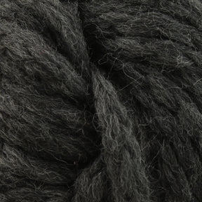 Close-up image of thick, dark grey Ushya Yarn by Mirasol from Knitting Fever / Euro Yarns, showcasing its fluffy texture and twisted strands.