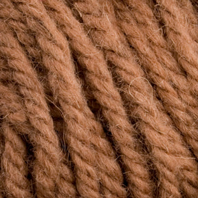 Close-up of thick, brown yarn from the Caledonian Dye Works Halcyon Yarn Classic Rug Wool Skein, showcasing its detailed texture and fibers. The yarn is tightly wound and appears coarse with visible individual strands and slight fuzziness, ideal for weavers crafting with this quality Rug Wool.