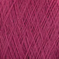 Close-up of pink JaggerSpun Maine Line 2/20 Yarn by Jagger Brothers, Inc., woven in a crisscross pattern. The texture of the medium-grade wool is visible, with individual fibers and threads interlaced to form a dense, intricate mesh. The overall appearance is soft and slightly fuzzy.