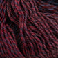 Close-up image of a bundle of intertwined Knitting Fever Painted Desert Yarn by Euro Yarns in shades of red, maroon, and dark gray. The texture is visible, showing the tightly twisted superfine weight fibers and the rich, variegated colors with long color changes, creating a visually appealing pattern perfect for lightweight accessories.