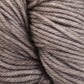 Close-up of a skein of Malabrigo Rios yarn by Malabrigo Yarn in a soft, neutral brownish-grey color. The twisted strands are tightly wound together, showcasing the smooth texture and slight sheen of the superwash fibers.