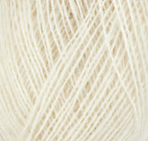 A close-up view of a ball of cream-colored Einband Lopi yarn from Berroco, Inc. The fibers are tightly wound, creating a detailed texture. The soft, fuzzy strands intersect and overlap, showing the intricate pattern reminiscent of stranded colorwork.