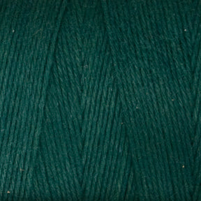 Close-up image of Maurice Brassard's Medium Cotton 16/8 Mop Yarn in a dark green hue, showcasing its smooth and tightly woven texture. The evenly aligned fibers deliver a rich, deep green color that is perfect for knitting or weaving projects. This sturdy cotton yarn appears soft and of high quality.