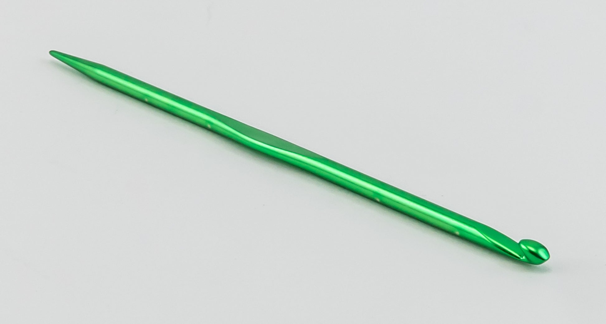 An Accessories Unlimited Silvalume Handi Tool, featuring a green crochet hook with a smooth, shiny metal surface, is placed on a white background. This versatile tool is perfect for your knitting and crochet projects.