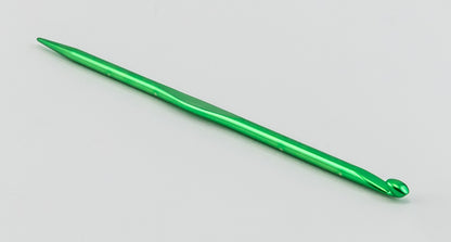 An Accessories Unlimited Silvalume Handi Tool, featuring a green crochet hook with a smooth, shiny metal surface, is placed on a white background. This versatile tool is perfect for your knitting and crochet projects.