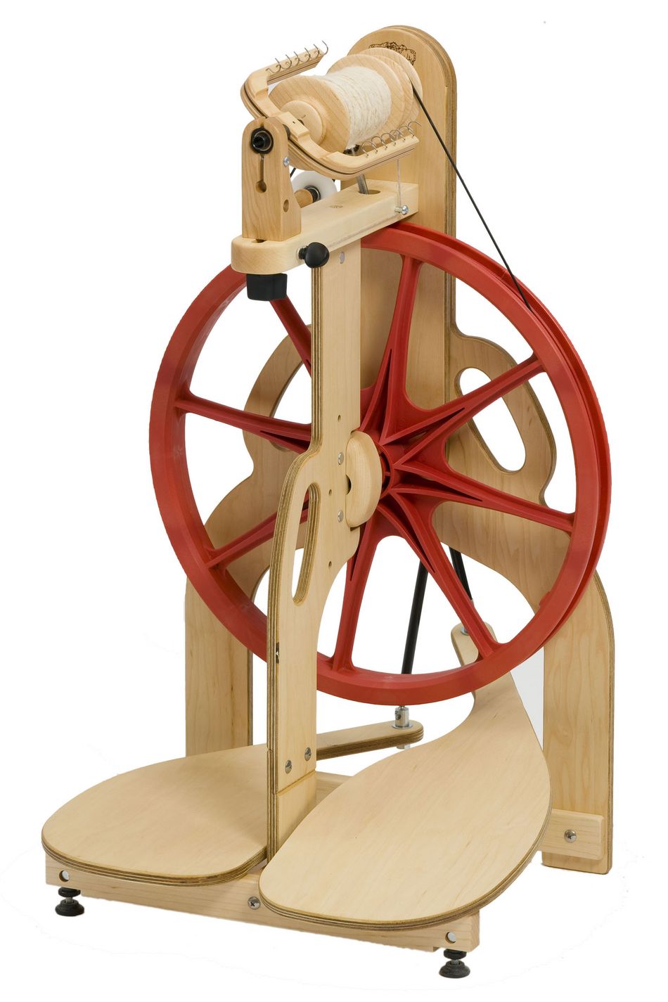 A Schacht Ladybug Spinning Wheel, designed by Schacht Spindle Co., is shown with its distinctive large red wheel. This spinning wheel features two foot pedals at the base and a mounted spool with white yarn on top. Its sturdy construction boasts smooth finishes and metal components, utilizing scotch tension for precise yarn control.