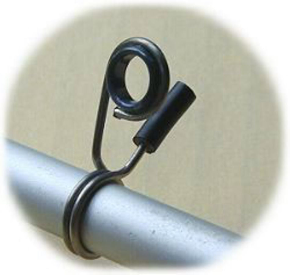 A close-up view of the Majacraft E System Flyer & Hook by Majacraft Co. shows the metal component affixed to a cylindrical rod. The component features a looped wire encircling the rod and extending into a small circular loop at the top. The background is blurred and neutral in color.