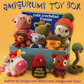 Cover of the "Amigurumi Toy Box" book by Ana Paula Rimoli, published by Martingale & Co. The image showcases a delightful collection of colorful, easy-to-make crocheted animal toys such as a bear, frog, bird, deer, and others arranged in and around a blue toy box. The text on the cover reads "cute crocheted friends".