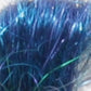 A close-up view of a bundle of Crystal Mylar Fiber by Foxglove Fiberarts Supply showcases densely packed, dark blue synthetic fibers with hints of green and purple iridescence, giving it a glossy and slightly tangled appearance. The novelty yarns create a shiny, textured surface adorned with shimmering highlights.