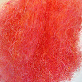 Close-up of Harrisville Dyed & Carded Wool Fiber by Harrisville Designs, showcasing a vibrant heathered pink hue. The bright, fuzzy textured material features tangled and intermixed fibers, creating a soft and fluffy appearance enhanced by the lighting.