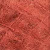 Close-up of a ball of Caledonian Dye Works' Victorian Brushed Mohair Yarn | Mini Skein, showcasing its fluffy and fibrous texture. The strands are interwoven, creating a dense and intricate pattern reminiscent of classic Victorian yarns.